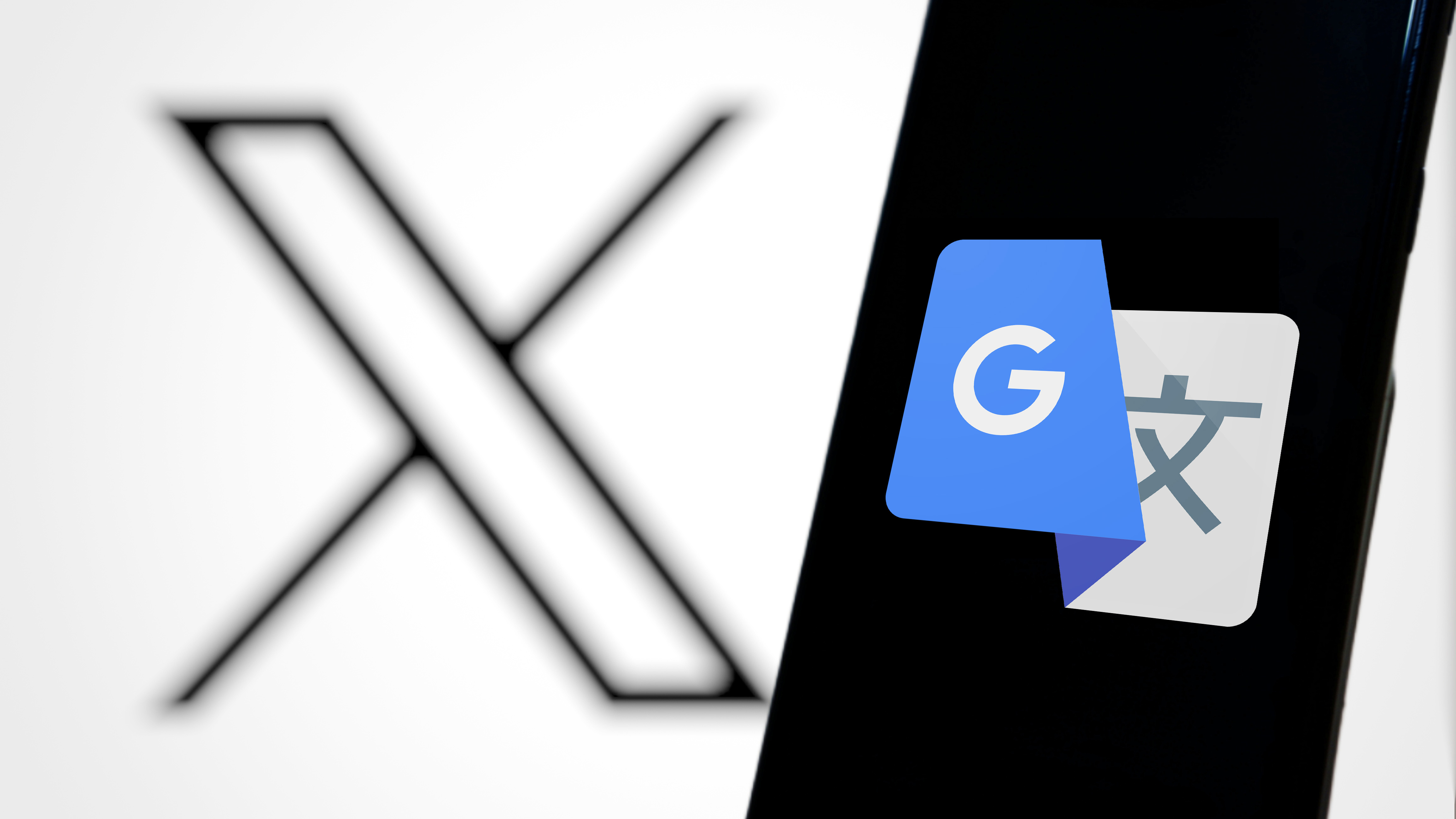 Xのロゴを背景にスマートフォンにGoogle翻訳のロゴが表示されている。